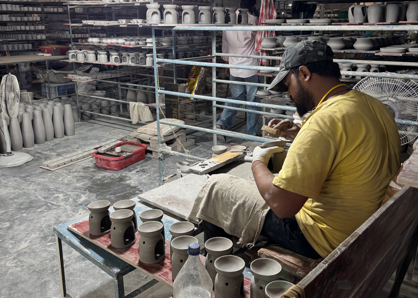 Potter finishing a cup by hand in Khurja